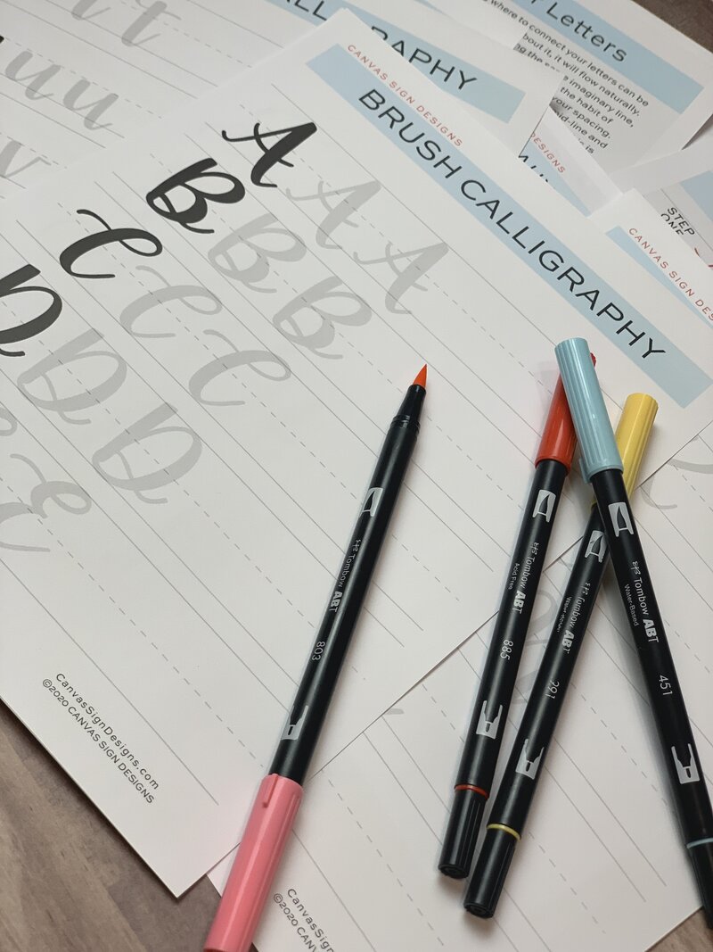 Hand Lettering workbook with black lettering pens