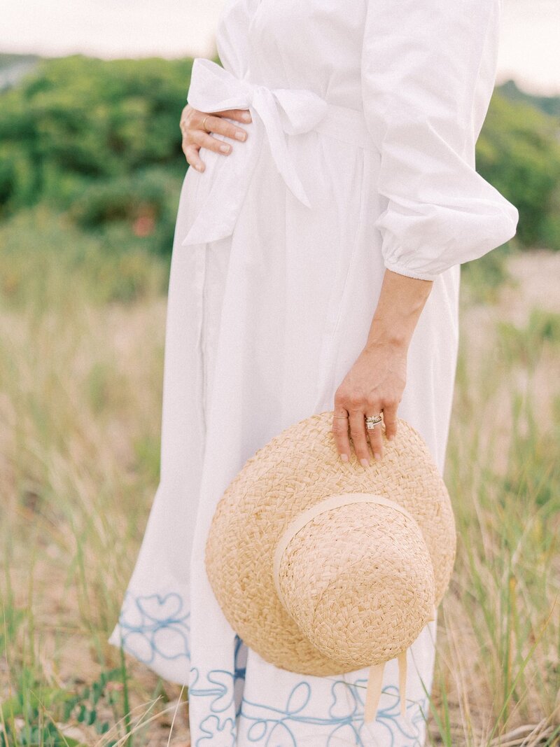 Mom holding belly beach maternity session
