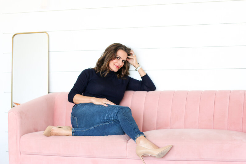 Elle Banks sitting cross legged on pink couch - Lifestyle Coaching for Women in Denver, Co - Elle Banks Coaching