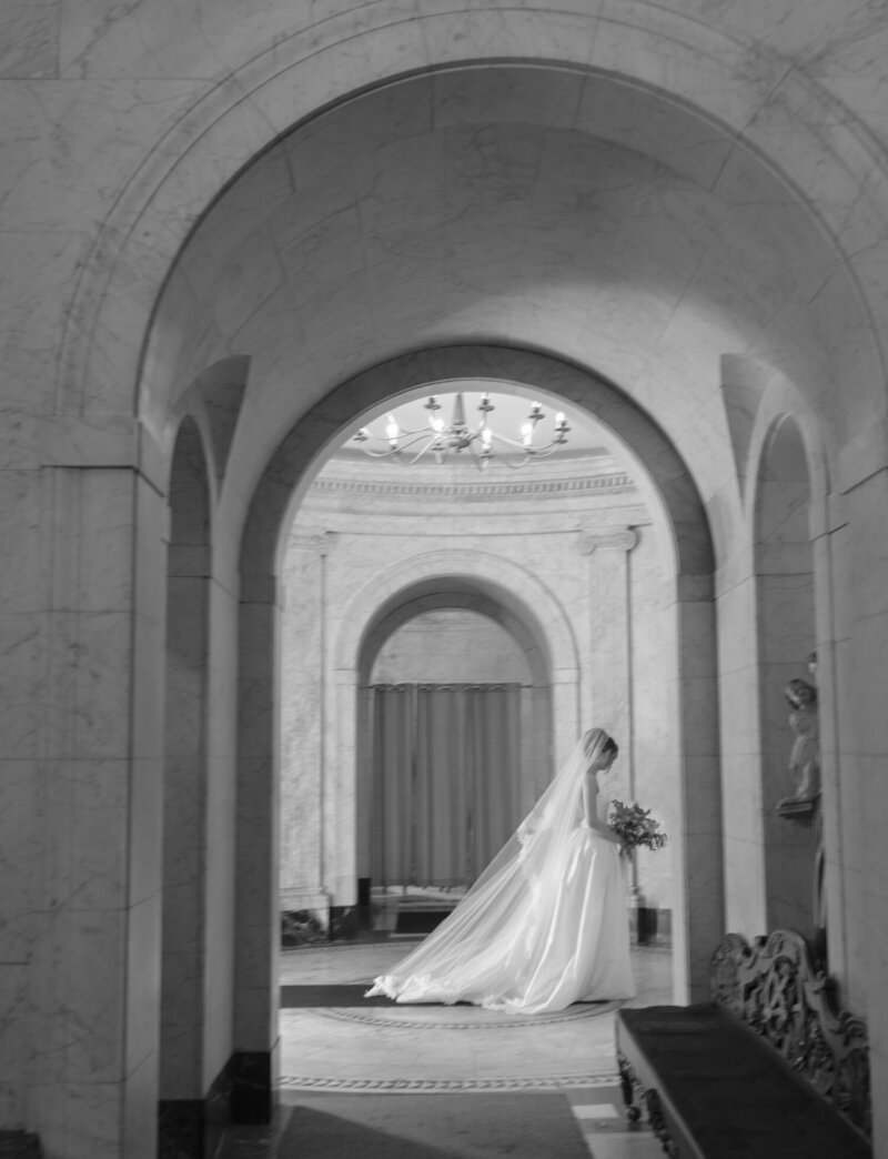 ethereal bride in long veil under cathedral arches, walking down the aisle, Michigan cathedral wedding