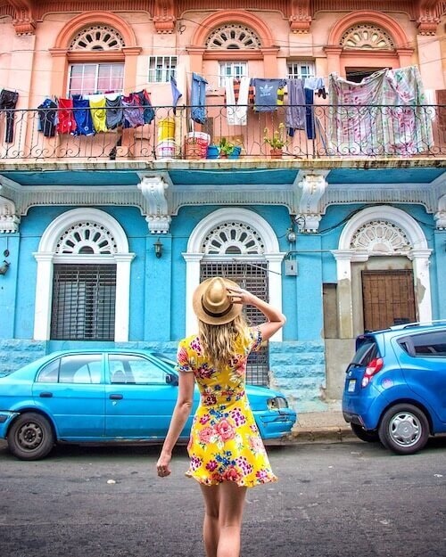 Designer walking in front of a colorful building in Panama City, Panama