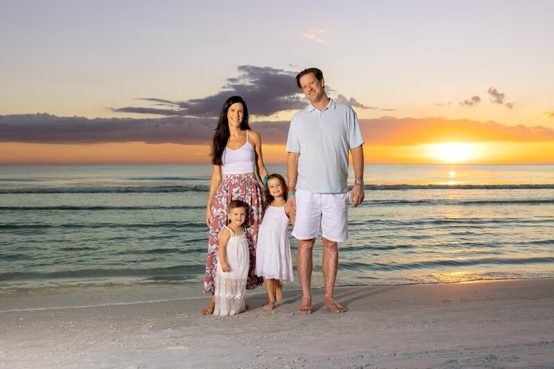 Family photo taken at sunset on a Sarasota beach