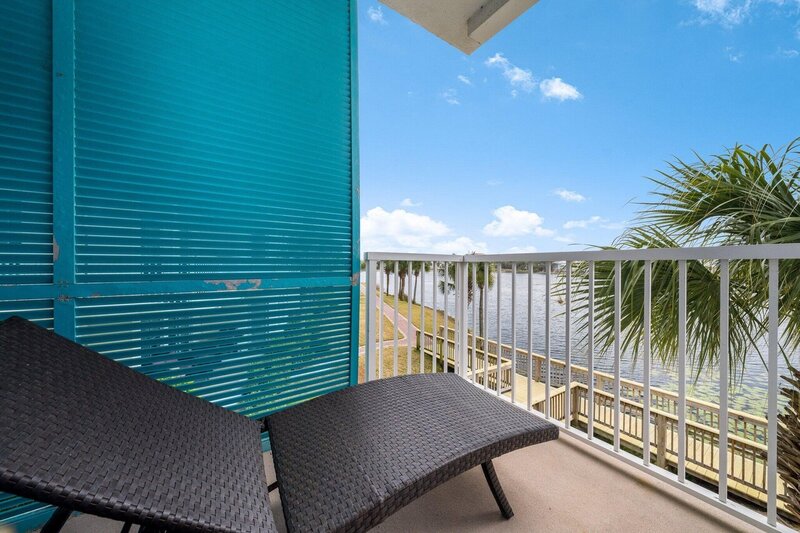 balcony overlooking lake with wicker lounger