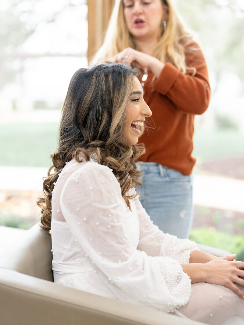 Bride getting ready in Canyonwood Ridge bridal suite with natural light and soft detailsBride getting ready in Canyonwood Ridge bridal suite with natural light and soft details