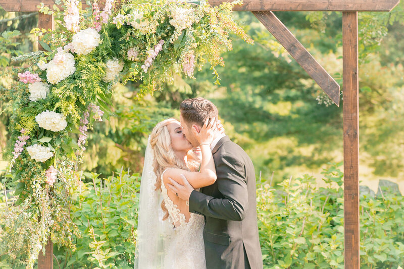A first kiss is captured at Airlie by Northern Virginia Wedding Photographer