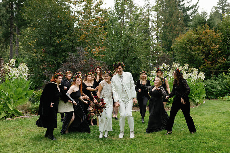 Group of people celebrating at wedding wearing flower crowns