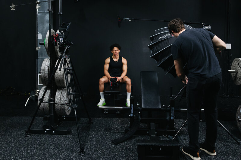 A behind-the-scenes photo capturing the creative process of a brand photoshoot, showcasing the team's expertise and attention to detail.