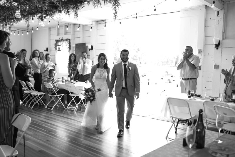 Bride and Groom walking into reception | Acadia Wedding