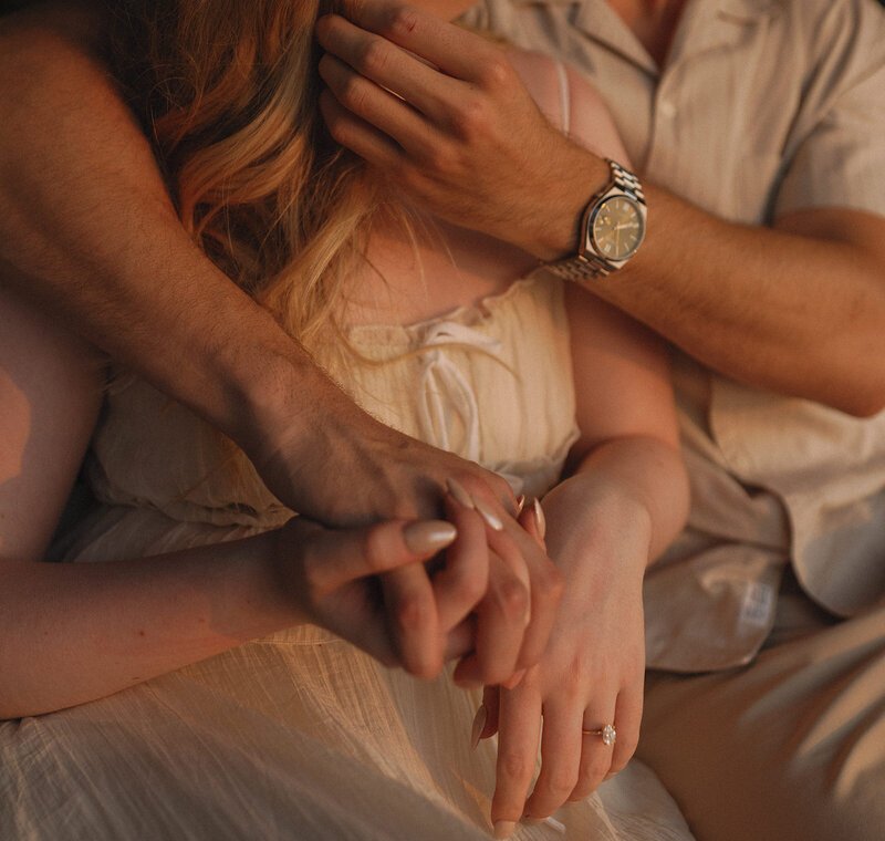 couples arms embraced and hands holding