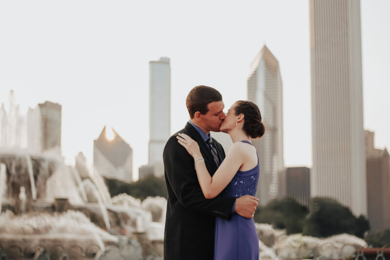 Catholic couple kisses after getting engaged at Buckingham Fountain in Chicago