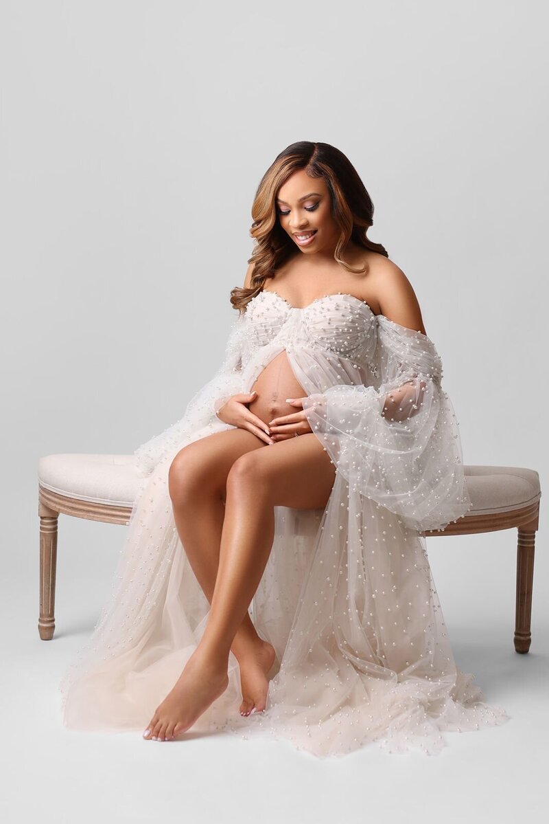Pregnant mom posing on a vintage chaise lounge