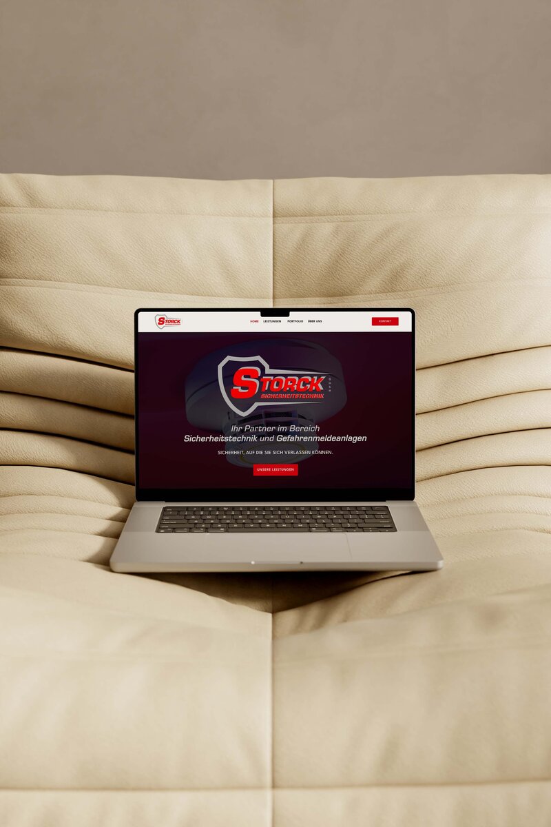 MacBook with open website in browser on a couch