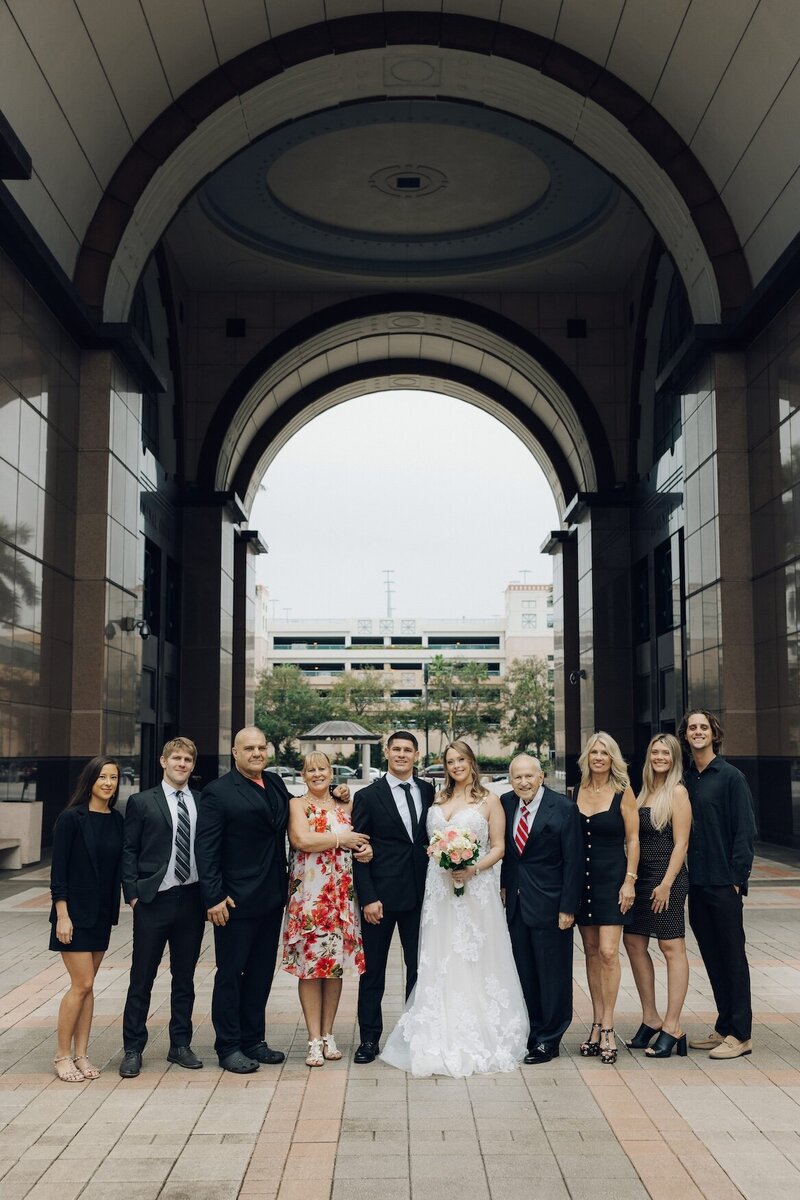 family poses for wedding photos