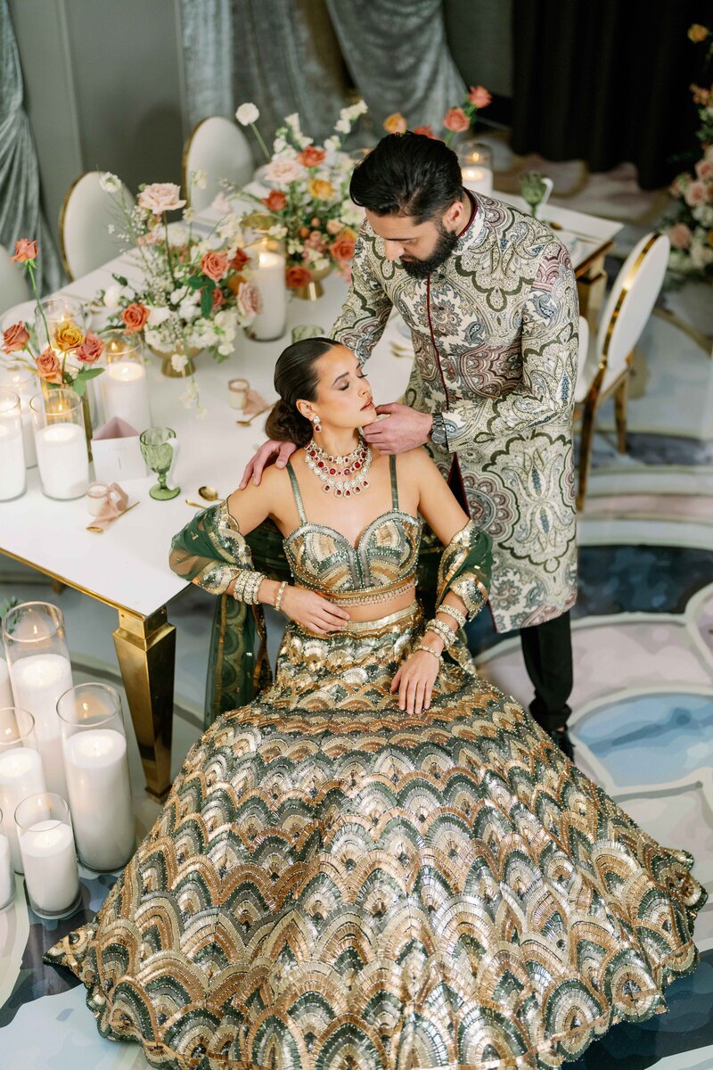 south asian bride and groom embracing each other in front of a lit farris wheel