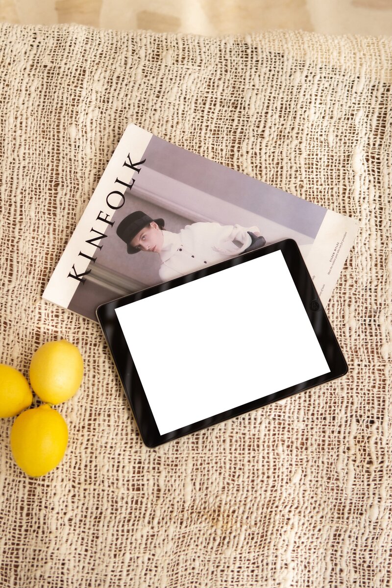 Amare Mockup Shop: iPad mockup positioned on a magazine with lemons beside it, creating a chic and refreshing boho-style environment.