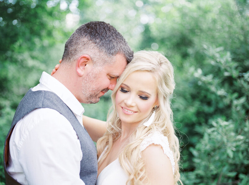 Groom staring at bride while bride looks down and smiles