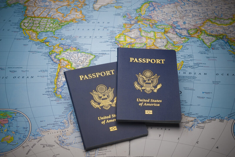 A couple of americal Passports on to of a world map