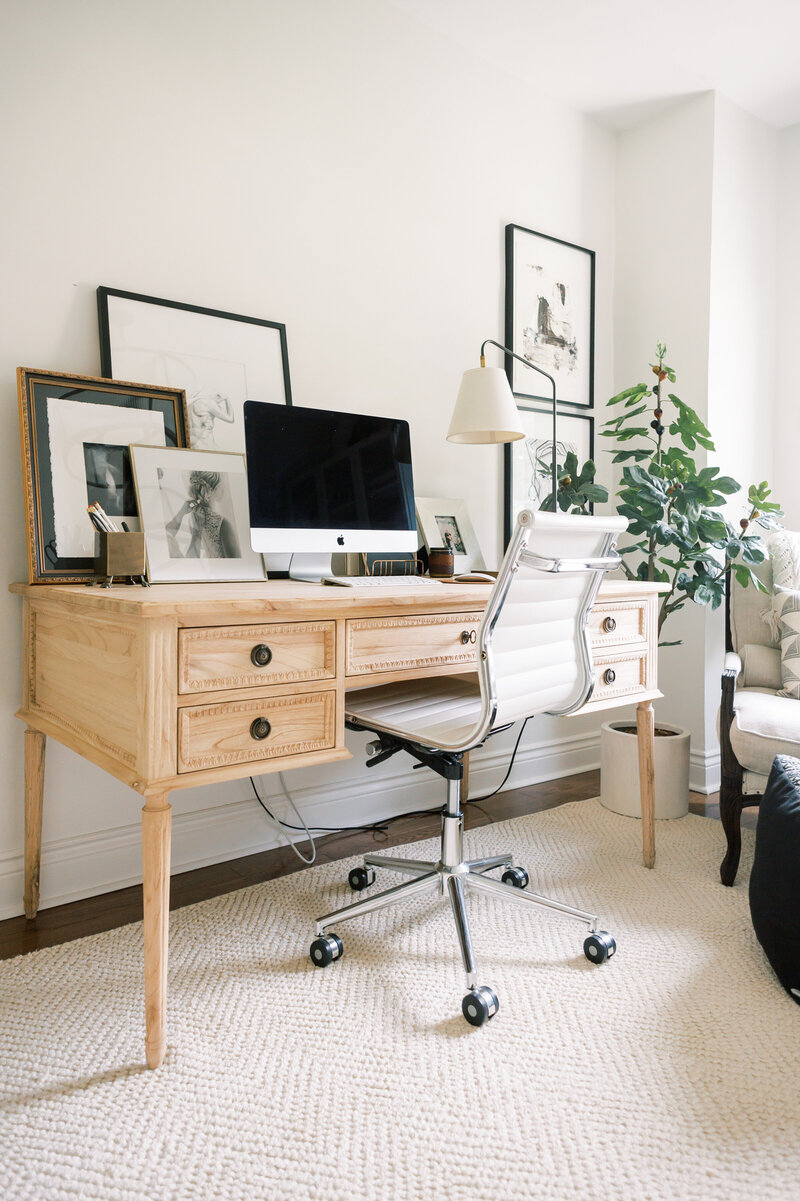 modern meets timeless home office with a carved wood desk ivory wool rug and modern art