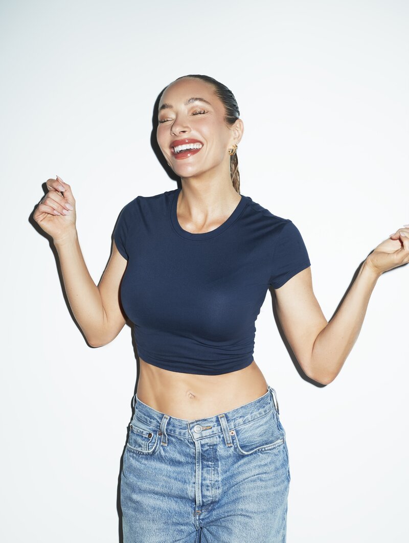 headshot image of alissa in jeans and a blue crop top