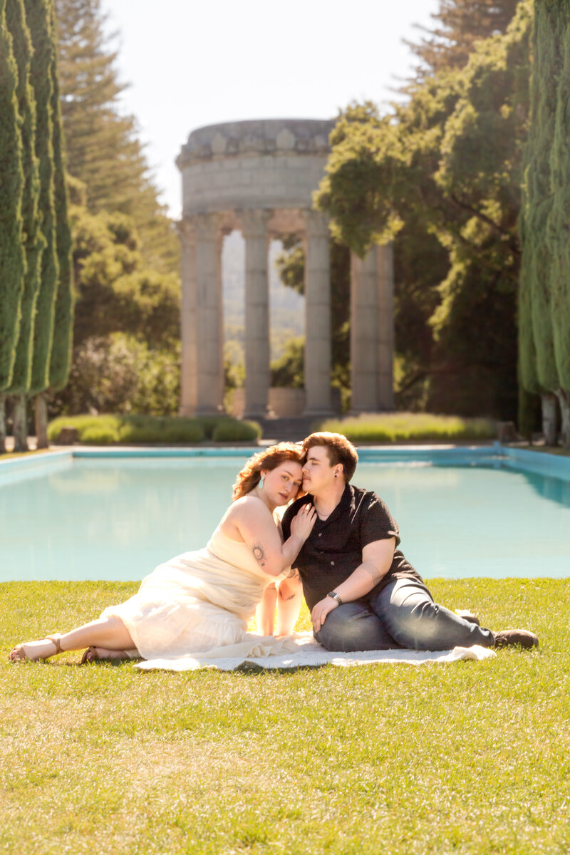 trans man and his fiancée take candid photos at pulgas water temple