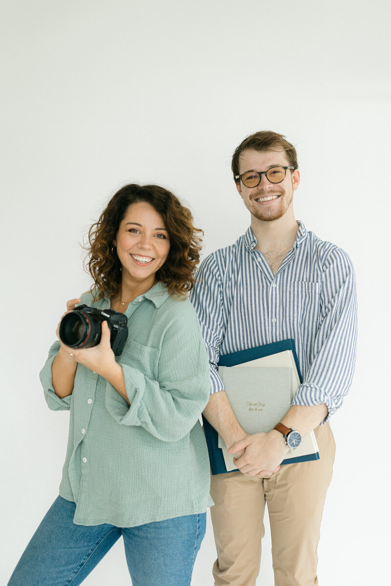 Woman wearing a periwinkle dress and holding a camera