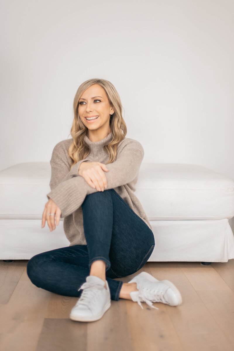 Dr. Tracy sitting on ground smiling