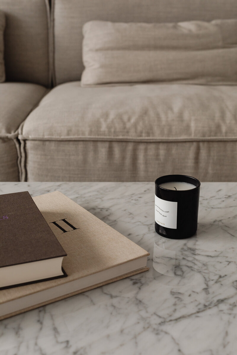 kaboompics_living-room-gray-beige-sofa-marble-coffee-table-coffee-table-books-candle-29391