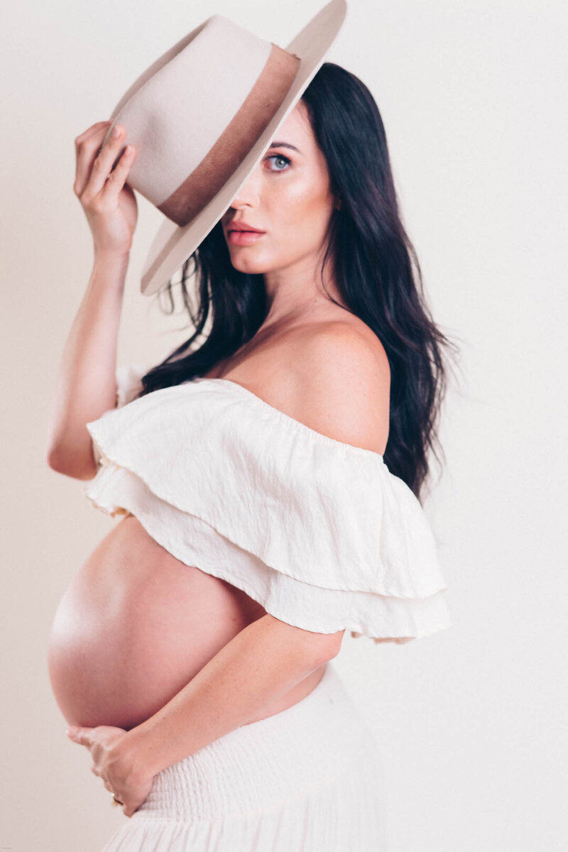 maternity studio photography with hat boho
