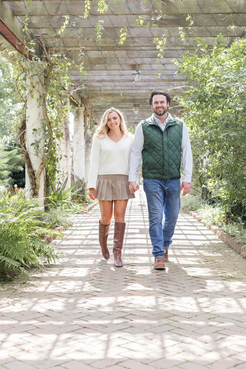 engaged-couple-walking-gardens-charlotte-nc