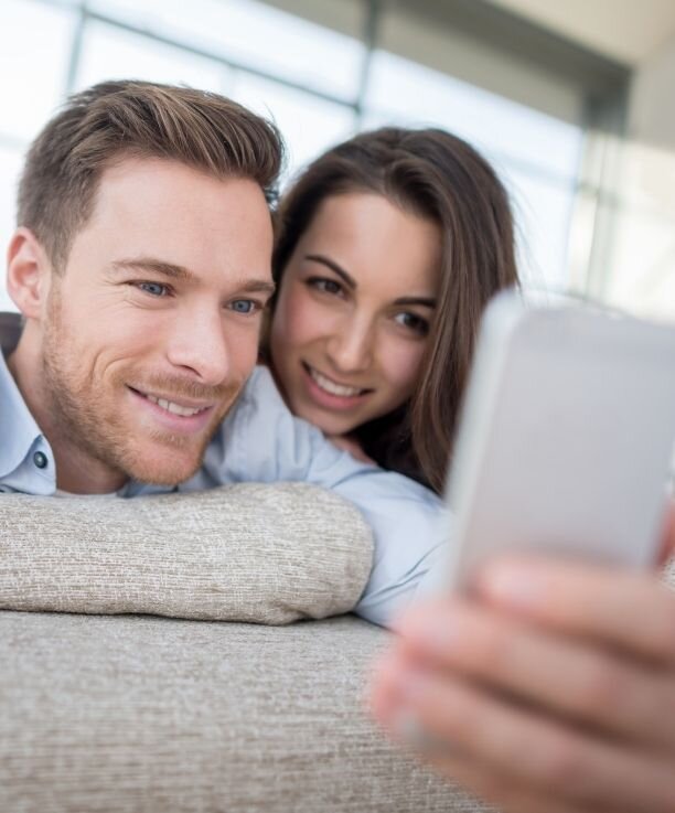 A couple smile as they pose for a selfie. This could symbolize the trust each have for one another after affair counseling in Florida.  Contact an affair recovery therapist in Florida for support in recovering from infidelity. We offer an affair recovery program and other services.