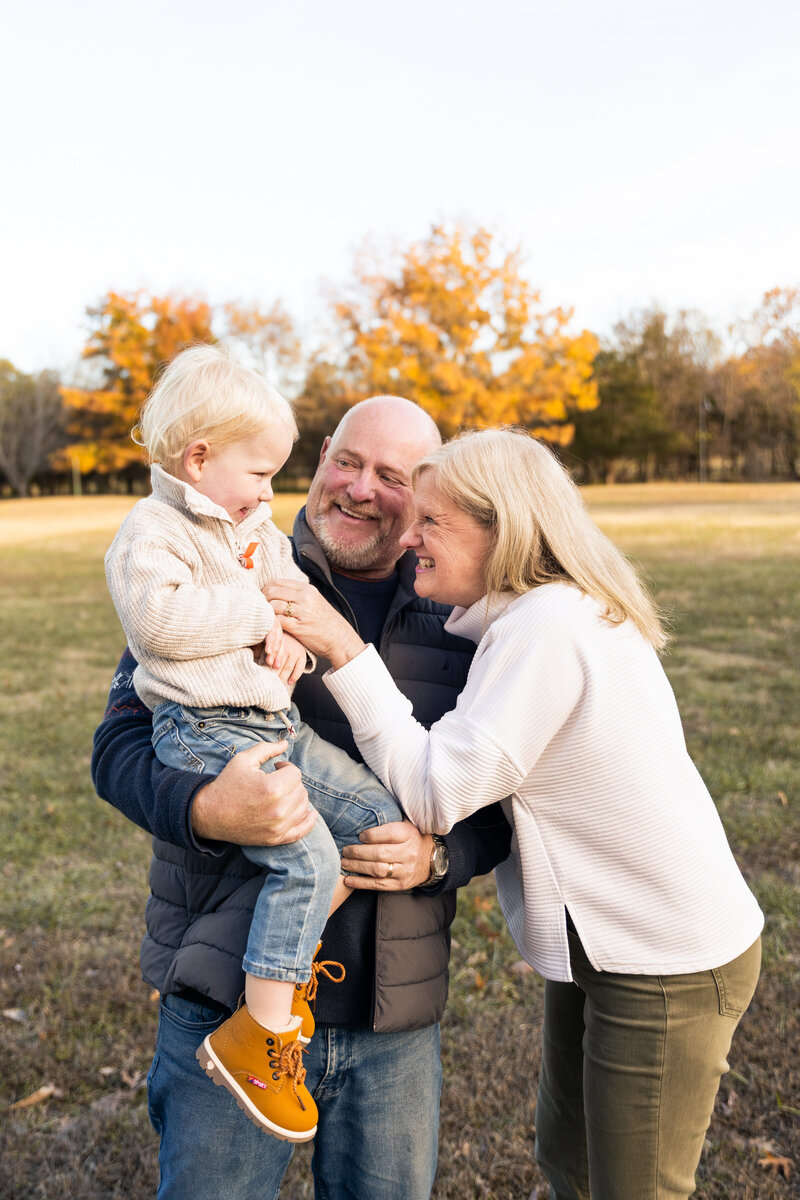 Outdoor Arkansas Family Session with grandparents tickling grandson