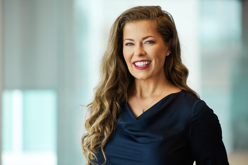 Female executive smiling during headshot session in McKinney