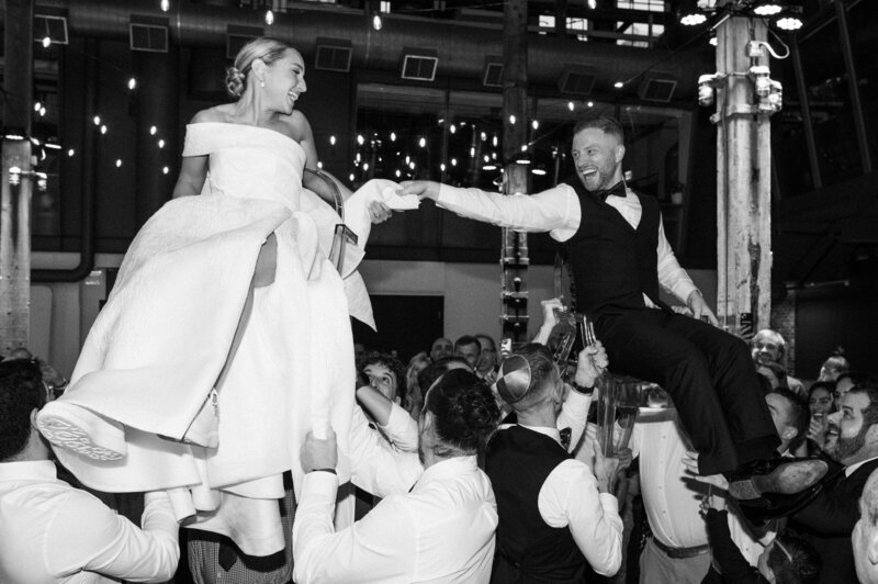 Couples lifted in a traditional Jewish dance, showcasing LIMCO’s capability to customize and perfect dances for culturally rich weddings.