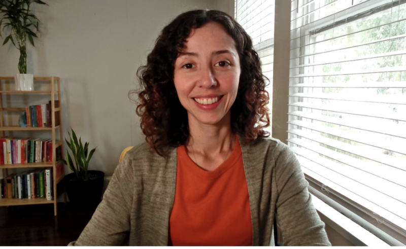 Zoe Schroeder, registered dietitian and fitness coach, smiling in workout gear, ready to guide clients through personalized fitness and nutrition programs.