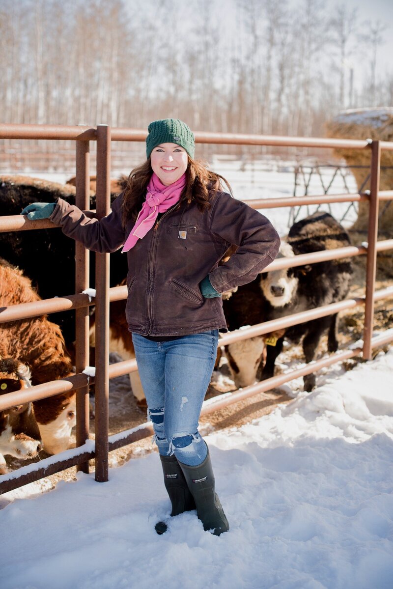 Carollyne Kehler standing in front of a cattle pen