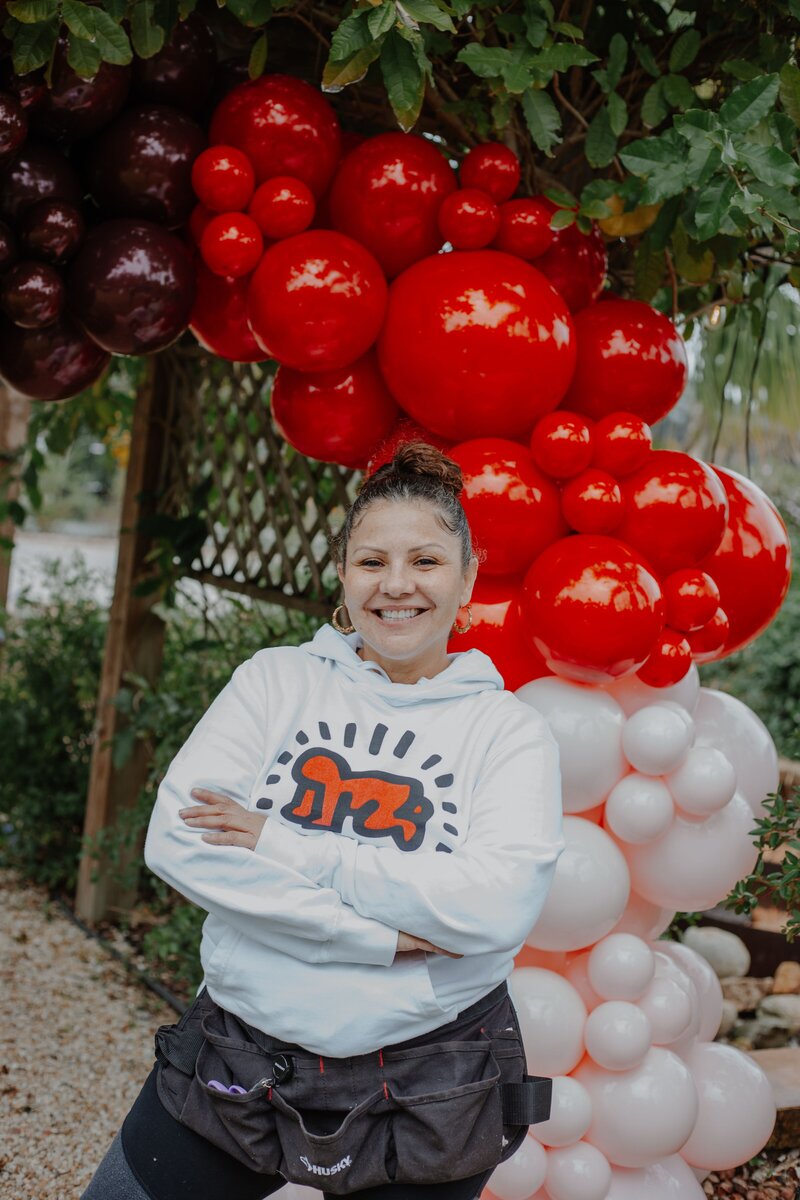 Natalie with styled Valentine's Day wedding balloons by Loononna, LLC in Orlando, FL.