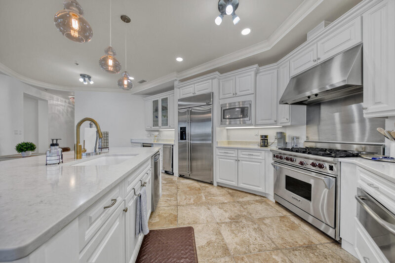 large gourmet kitchen with large island and stainless steel appliances