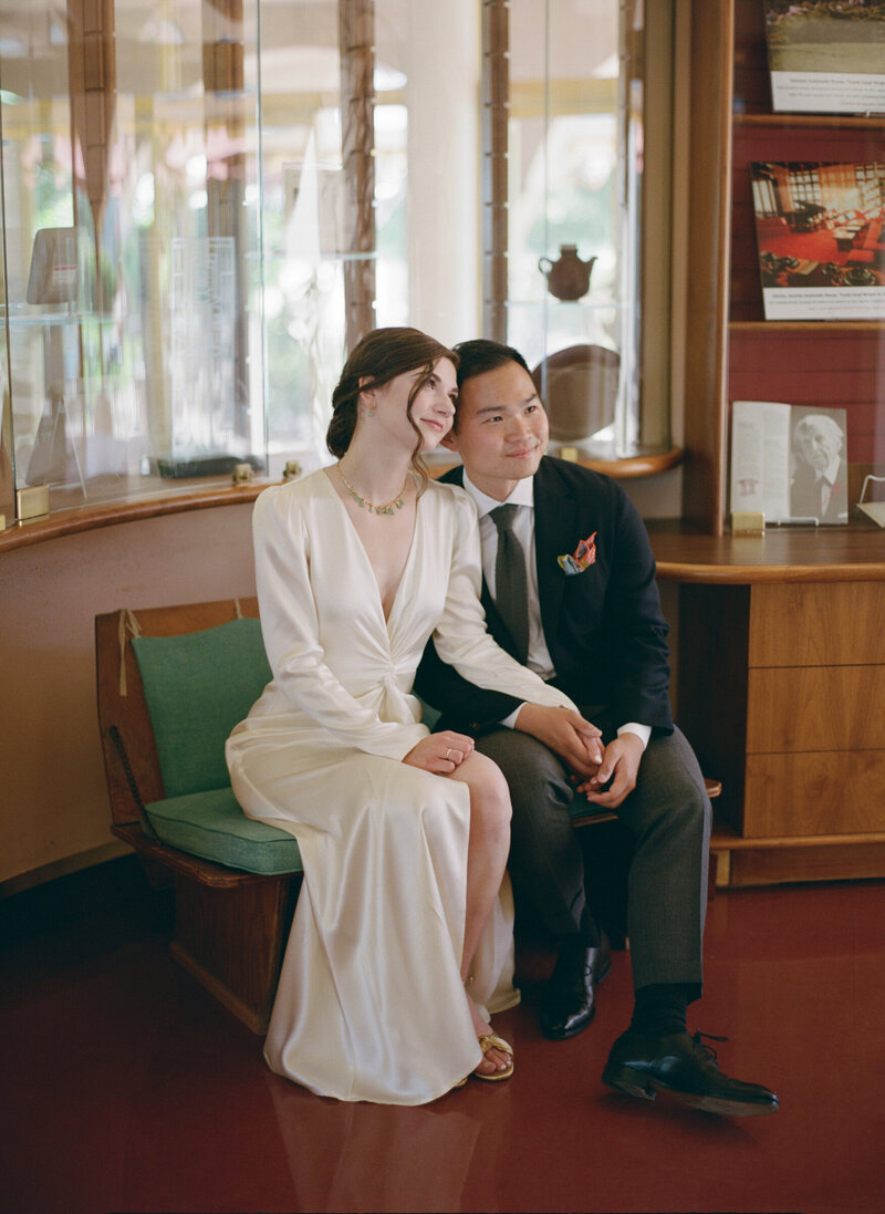 Couple seated indoors on mid-century furniture at Civic Center.