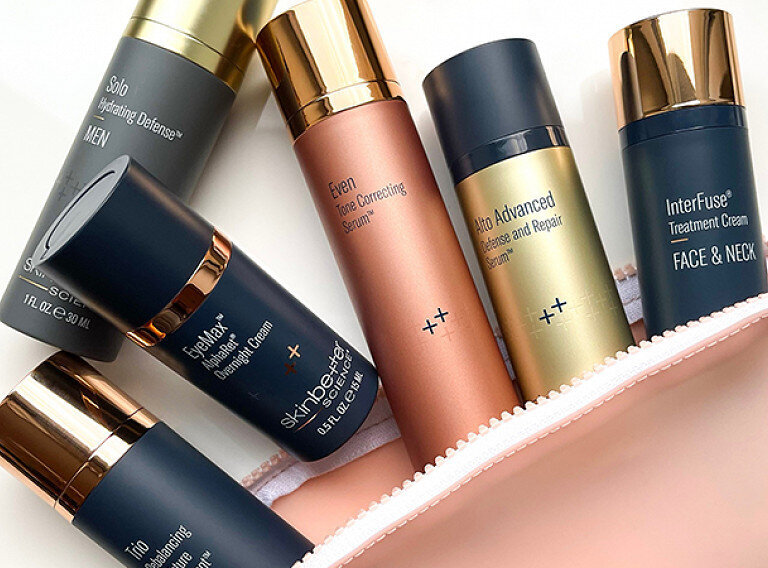 Medical grade skincare featuring SkinBetter Science products laid out on a table coming out of a pouch