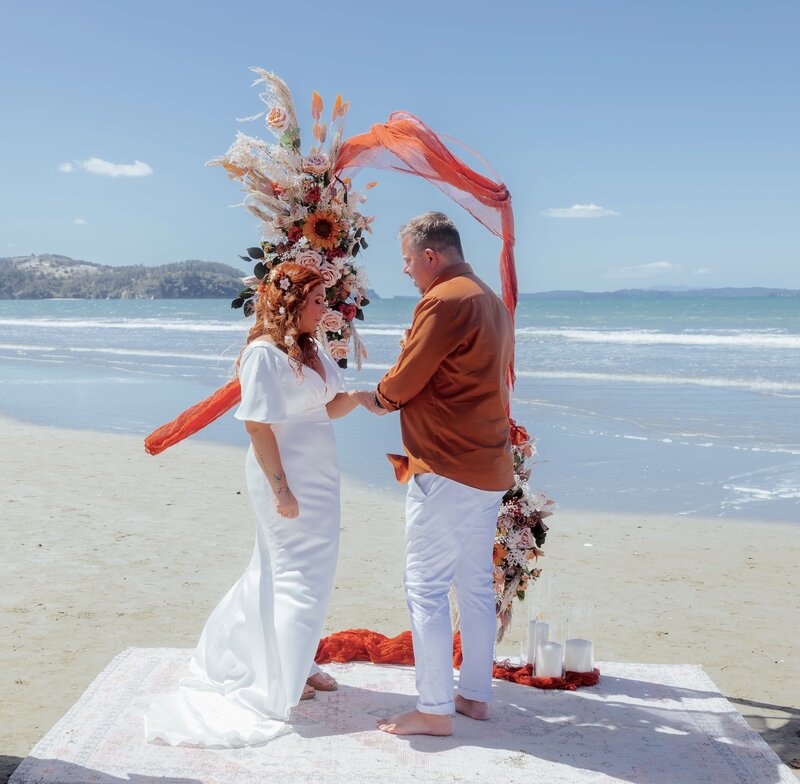 Affordable beach elopement package Auckland Bohemian chic wedding ceremony on the sand