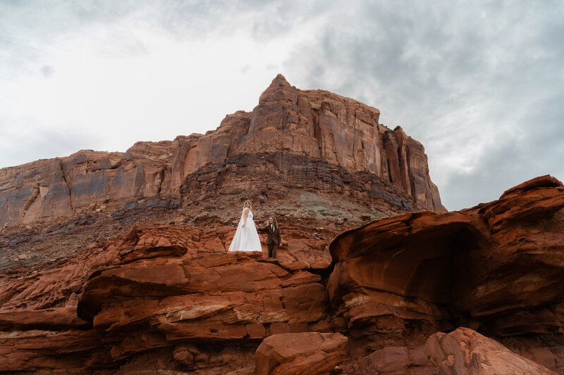 Couple exchanging vows at sunrise with Enchanted Rock and Turkey Peak rising behind them during intimate elopement
