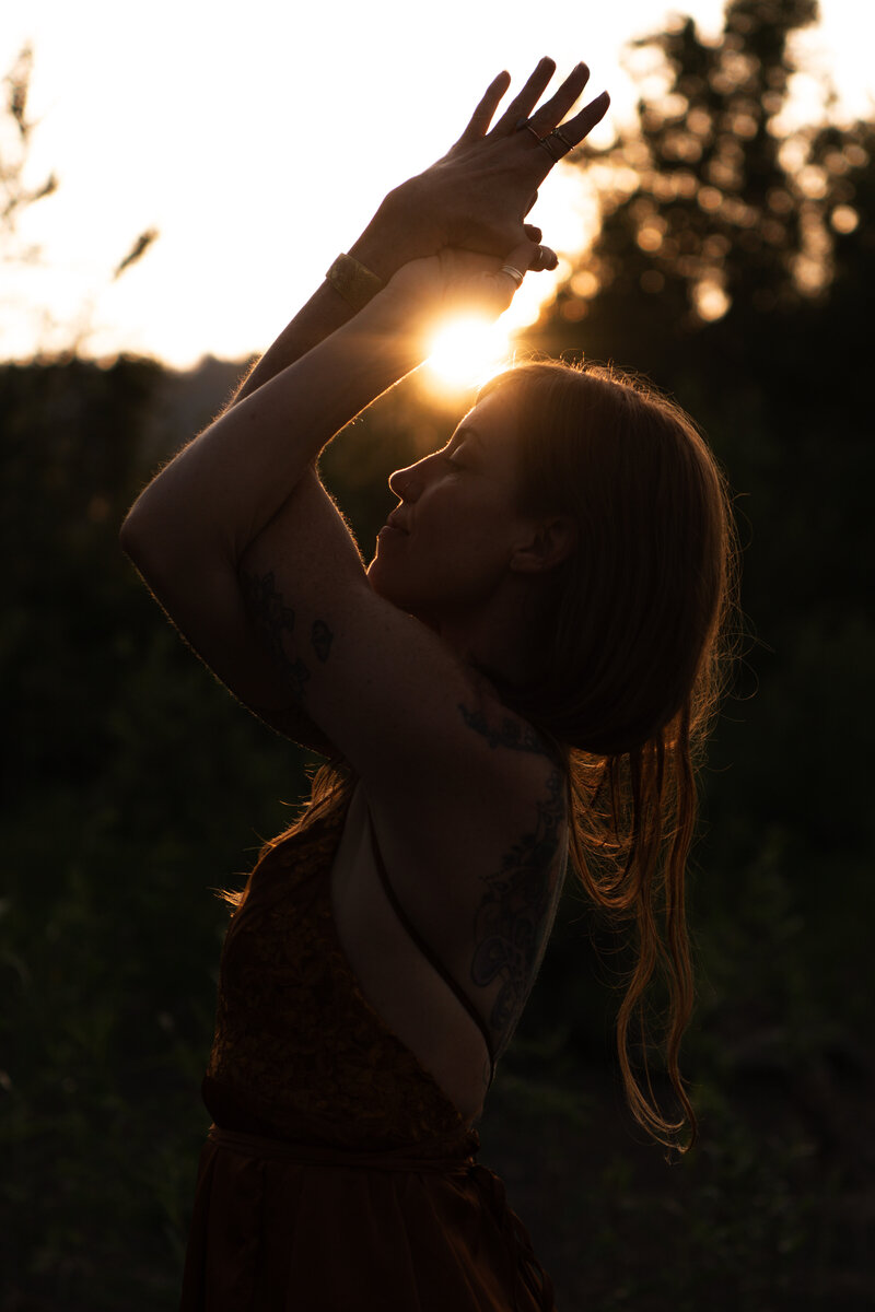 woman doing a yoga pose with a dark background