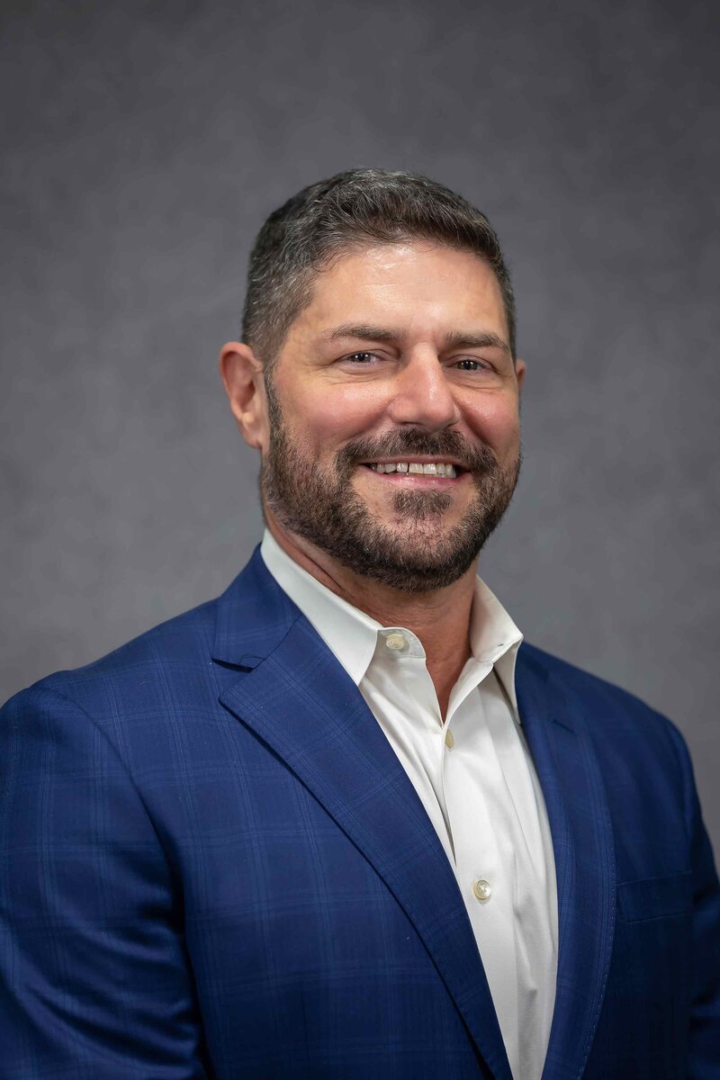 Professional corporate headshot of a man with a neutral background, featured in the Headshot Gallery Portfolio by Sophie K. Hunter