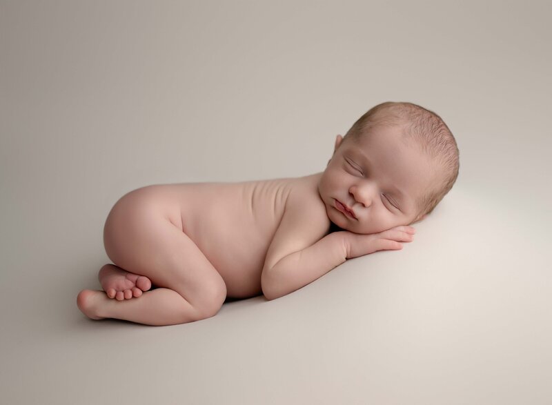 Newborn baby sleeping with bum out. Photo taken at Marietta Newborn photo studio in Woodstock, GA.