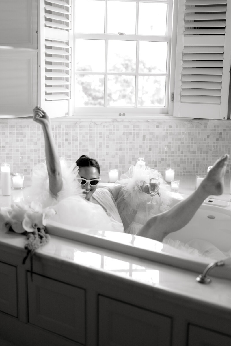 Wedding Photographer Newport RI | Rhode Island Caprio Captured Photography | Bride in a Bathtub Holding a Champagne Glass In a Tulle Robe