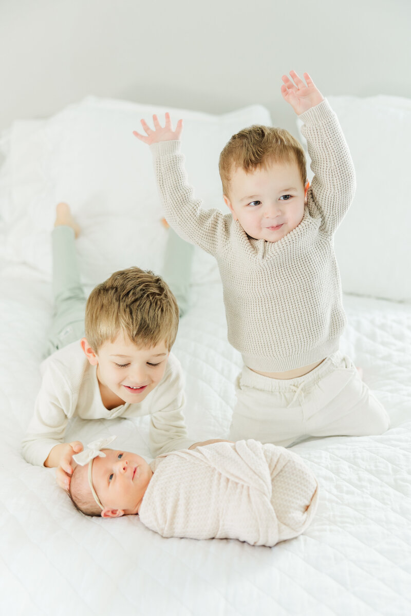 toddler brothers excited for newborn baby sister