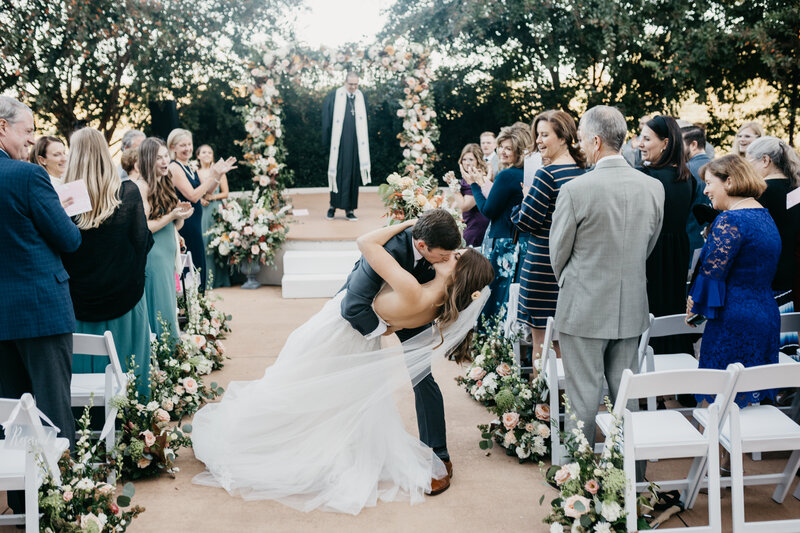 wedding ceremony outdoor couple kissing dipping