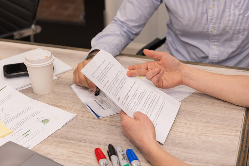 detail of hand pointing on a document during a meeting Atlanta Brand Photographer