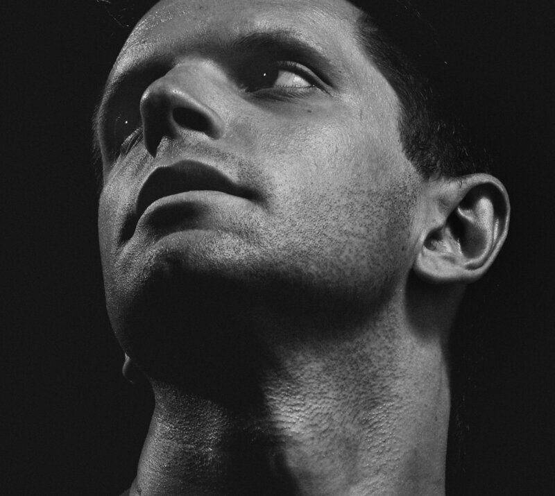 A photo of a man's face with smooth skin. Black and white photo.