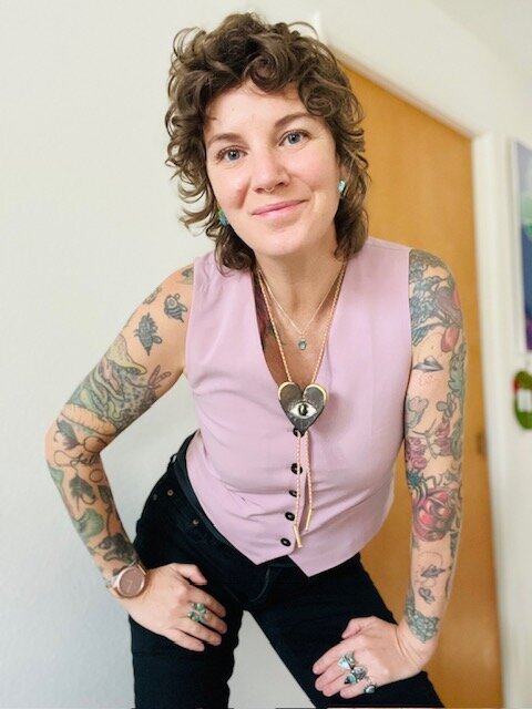 Holistic therapist Brie Huling smiles and is wearing a pink vest.